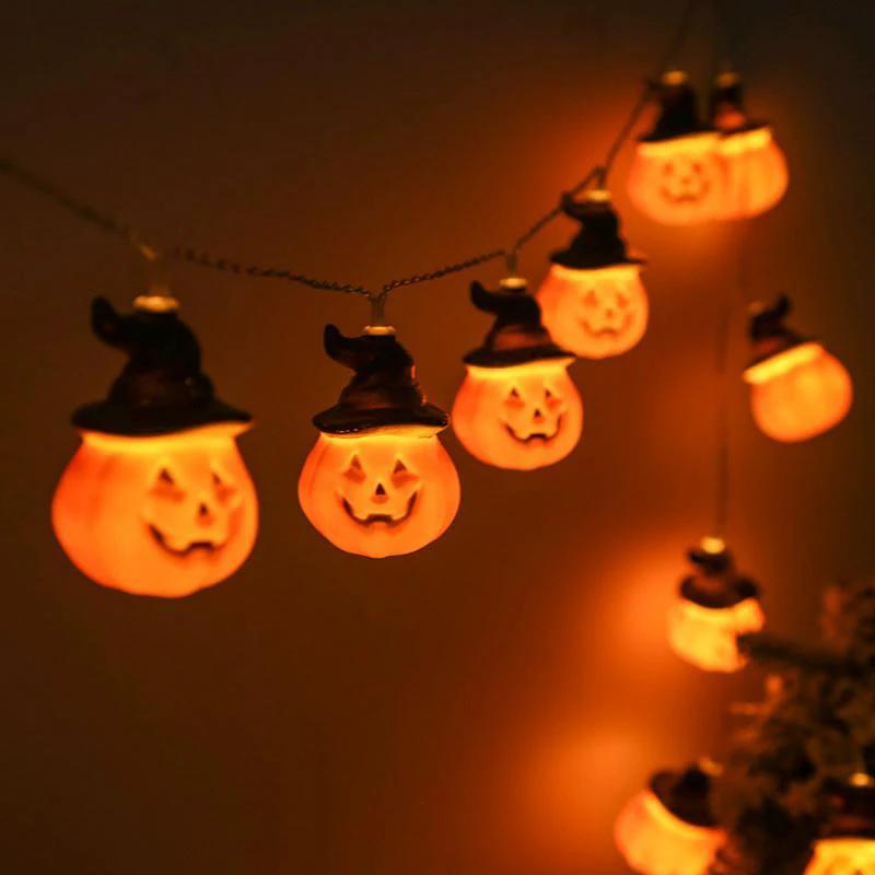 Glowing pumpkin garland Halloween with witch hats by Bowlift