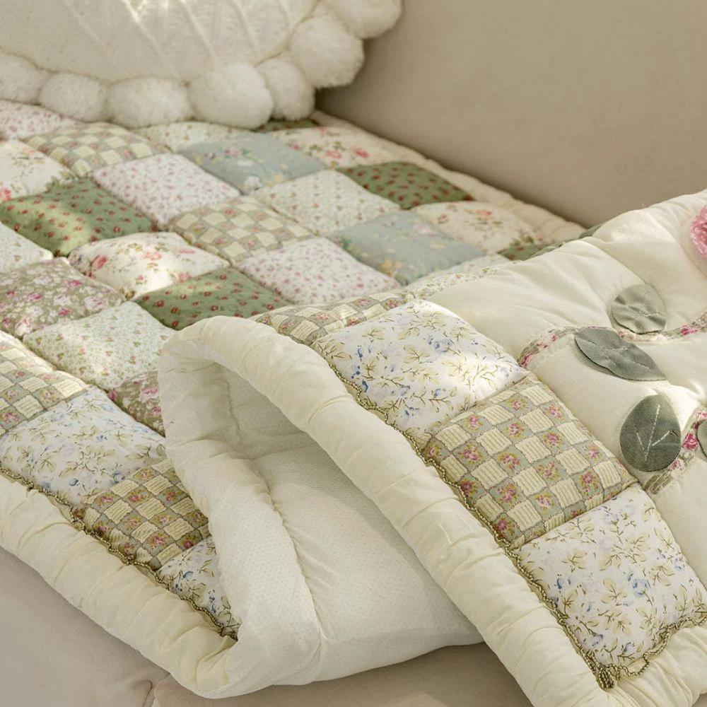 Floral Bloom Quilted Sofa Cover by Casa & Beyond.