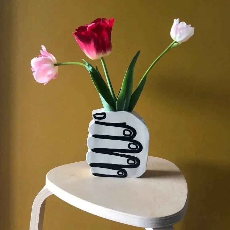 Hand Holding Flowers Vase by Bowlift