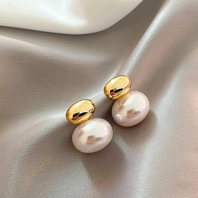 Classy Gold Accented Pearl Stud Earrings by BowLift