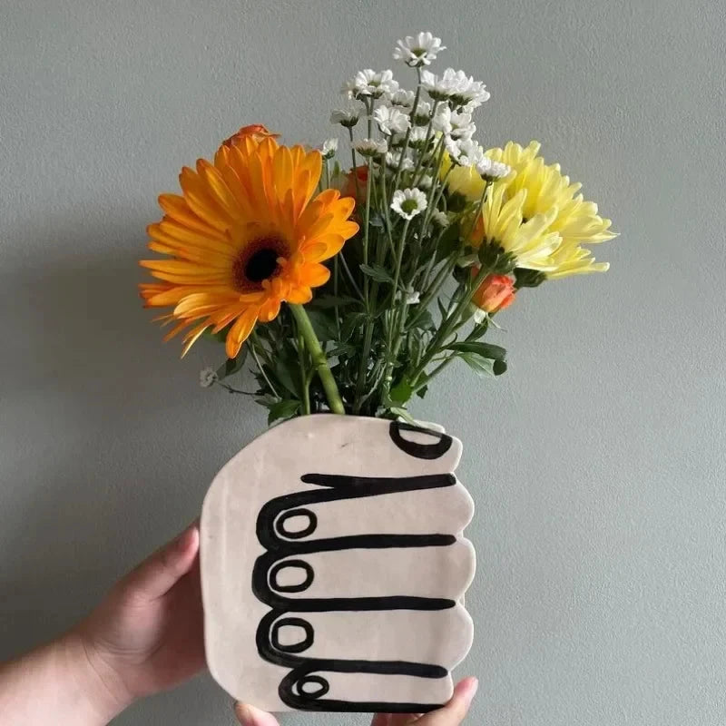 Hand Holding Flowers Vase by Bowlift